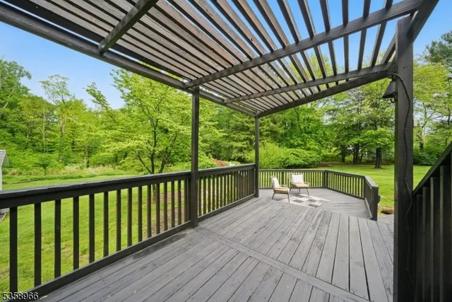 a view of balcony with wooden floor and fence