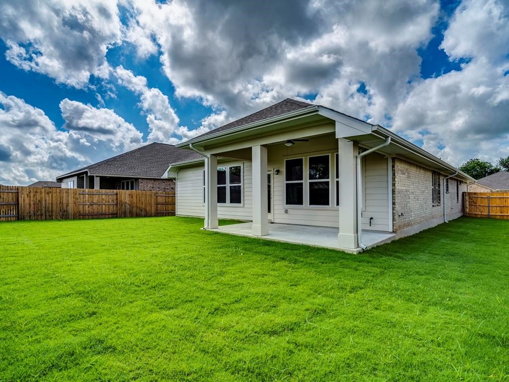 270 Rimrock Court Bastrop, TX 78602 - Photo 34 of 34 Step outside to a covered patio and landscaped backyard — a peaceful escape from the bustle of city life.