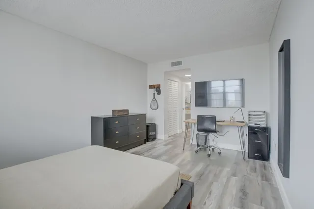 a living room with furniture a flat screen tv and view of kitchen