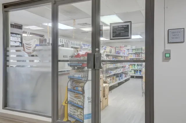 a living room with furniture and large windows