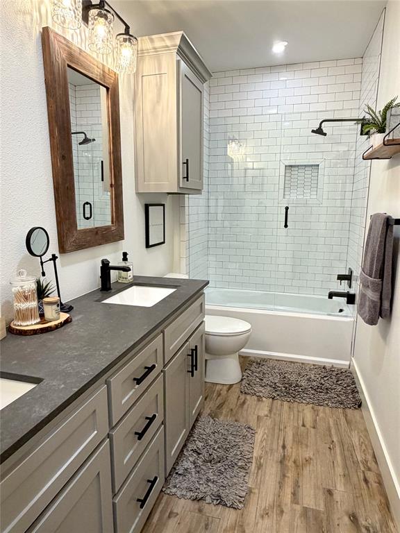 1304 Tinker Road Colleyville, TX 76034 - Photo 19 of 28 a bathroom with a tub sink toilet and a mirror