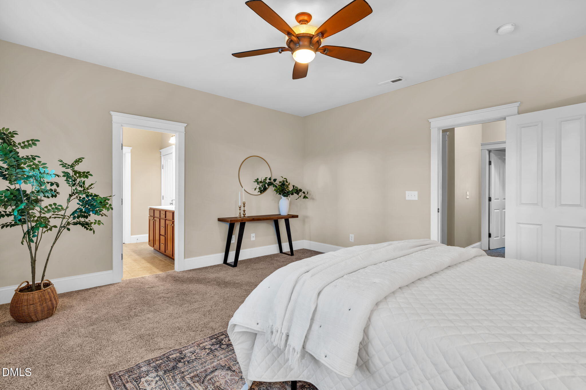 4324 Brighton Ridge Drive Apex, NC 27539 - Photo 19 of 37 a bedroom that has a bed and a potted plant