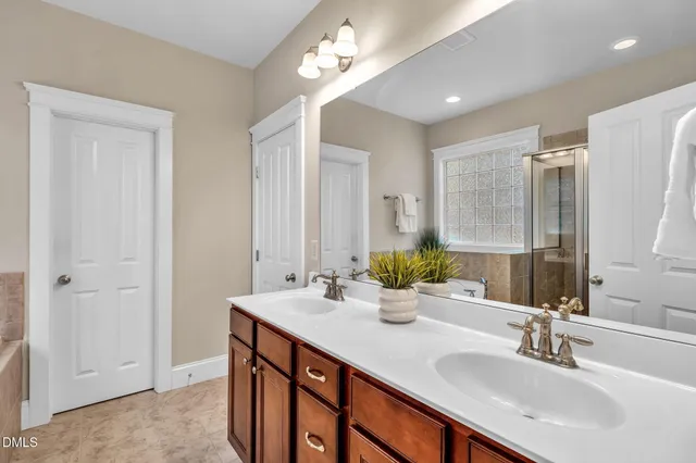 a bathroom with double vanity sinks and a mirror