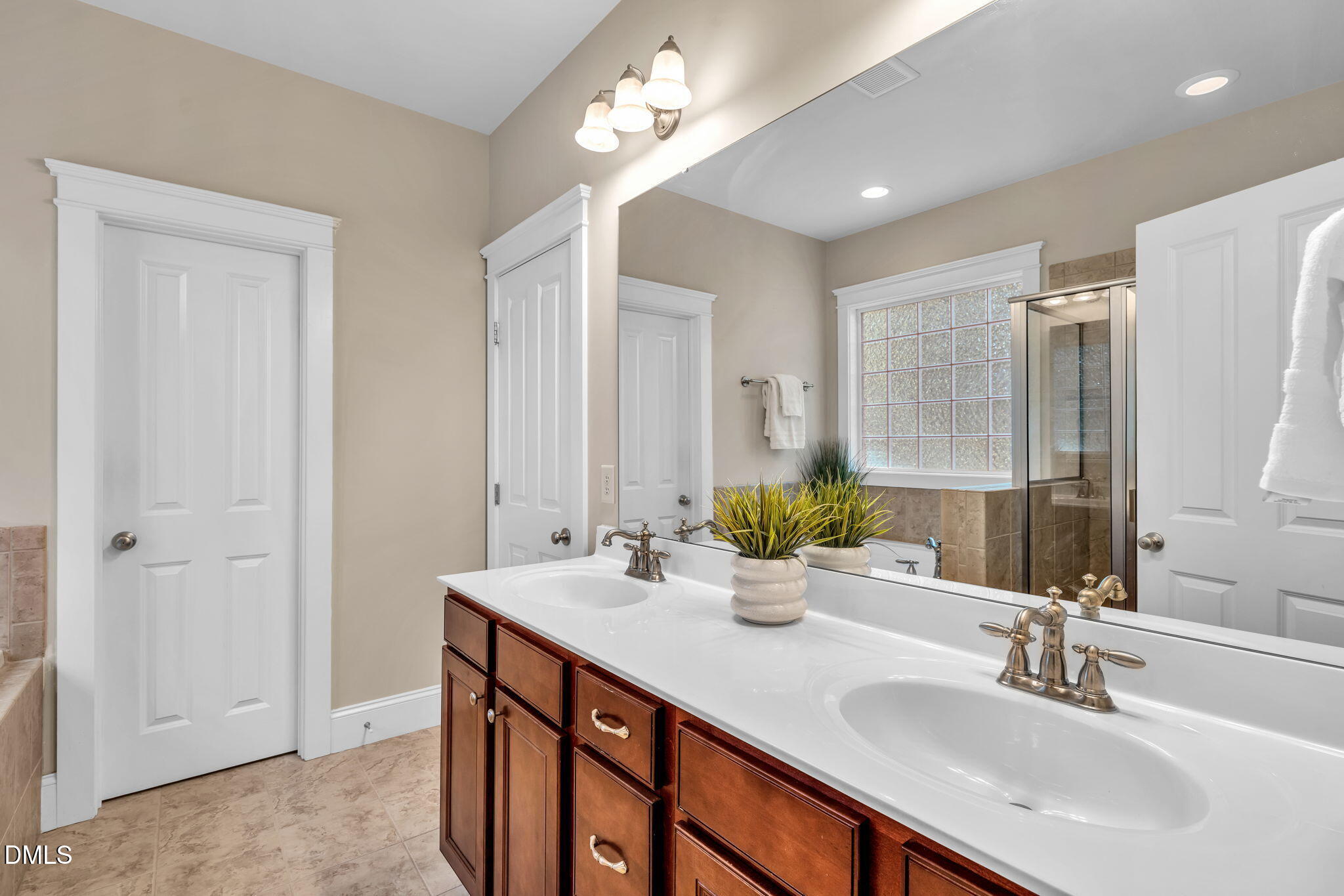 4324 Brighton Ridge Drive Apex, NC 27539 - Photo 20 of 37 a bathroom with double vanity sinks and a mirror