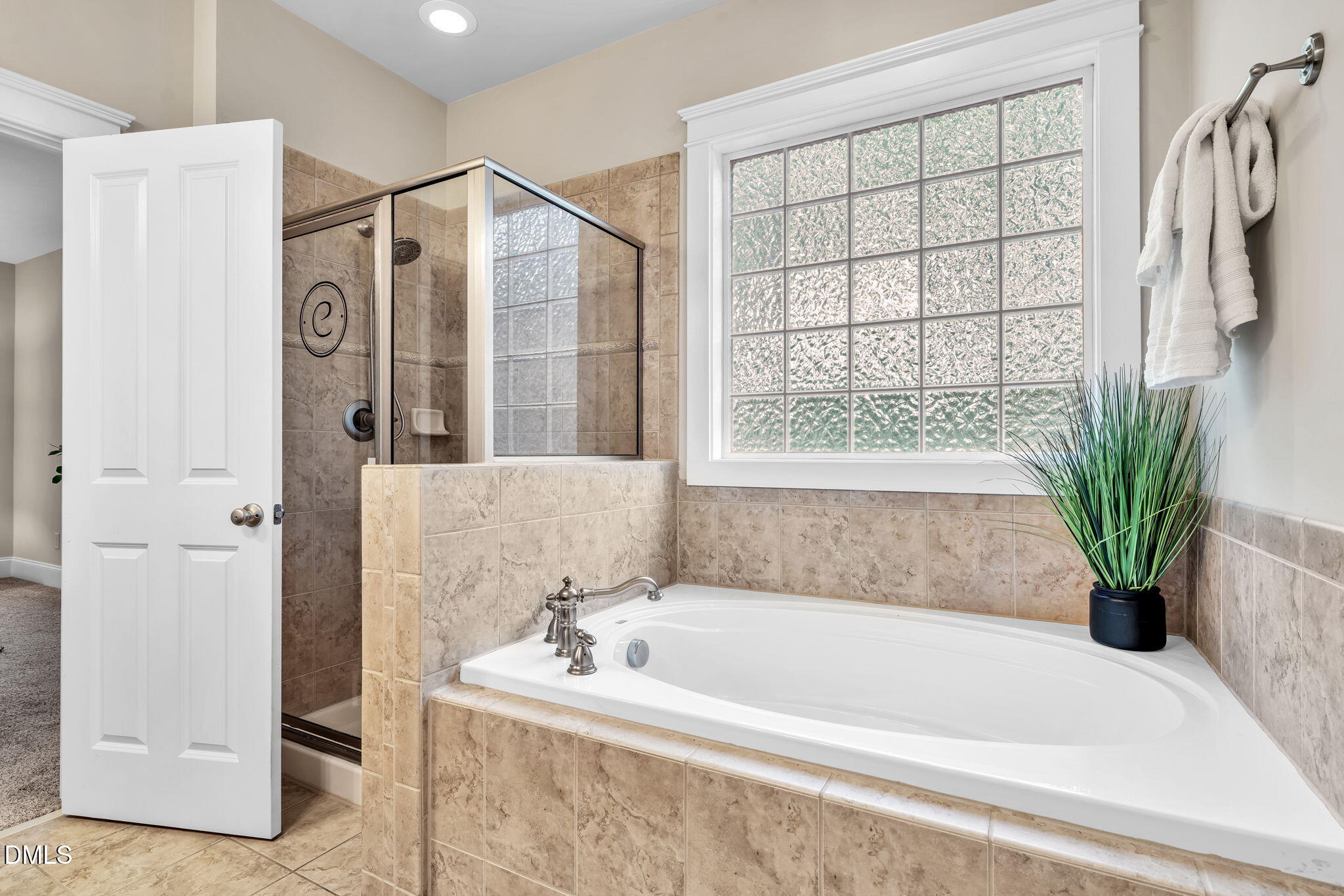 4324 Brighton Ridge Drive Apex, NC 27539 - Photo 21 of 37 a bathroom with a bathtub and a shower