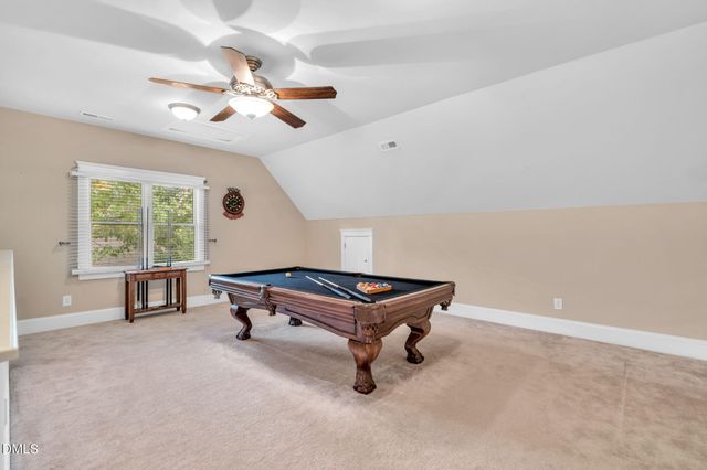 a room with pool table and a window