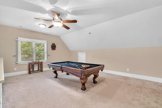 a room with pool table and a window