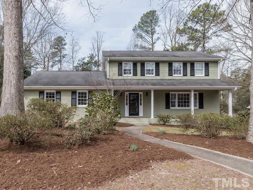 1213 Hunting Ridge Road Raleigh, NC 27615 - Photo 1 of 25 a front view of a house with yard and trees