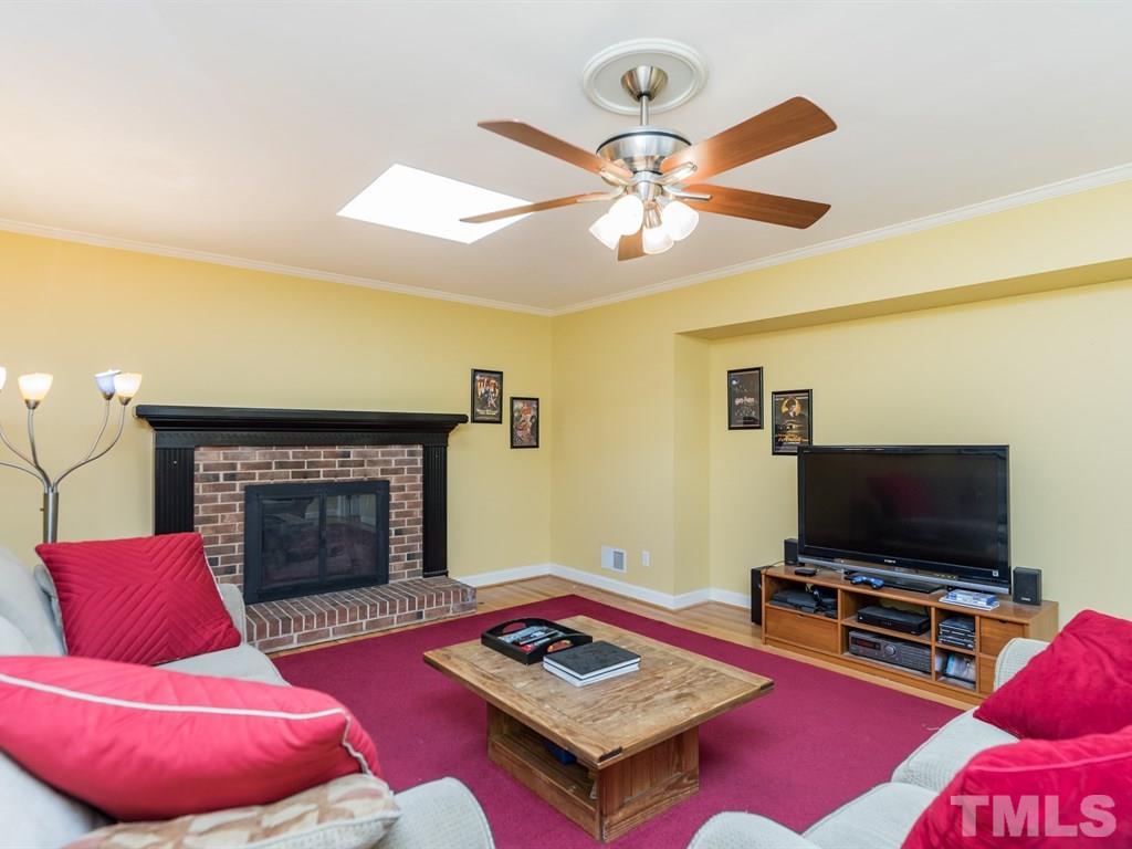 1213 Hunting Ridge Road Raleigh, NC 27615 - Photo 14 of 25 a living room with furniture and a flat screen tv