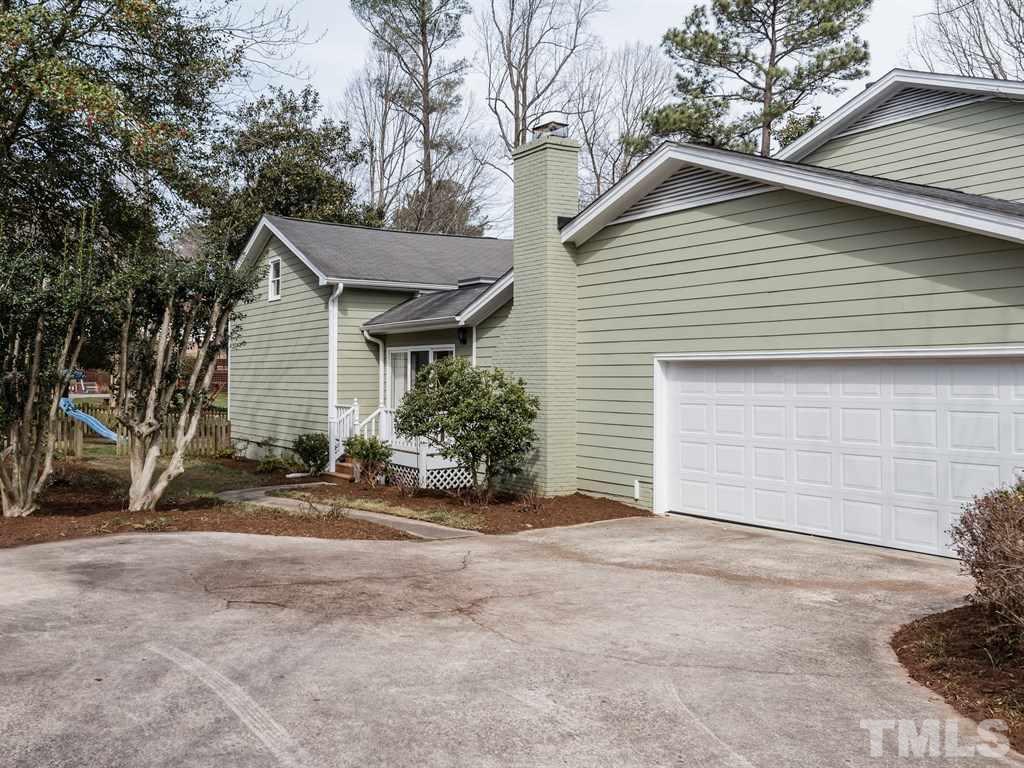 1213 Hunting Ridge Road Raleigh, NC 27615 - Photo 3 of 25 a view of a house with a yard and garage