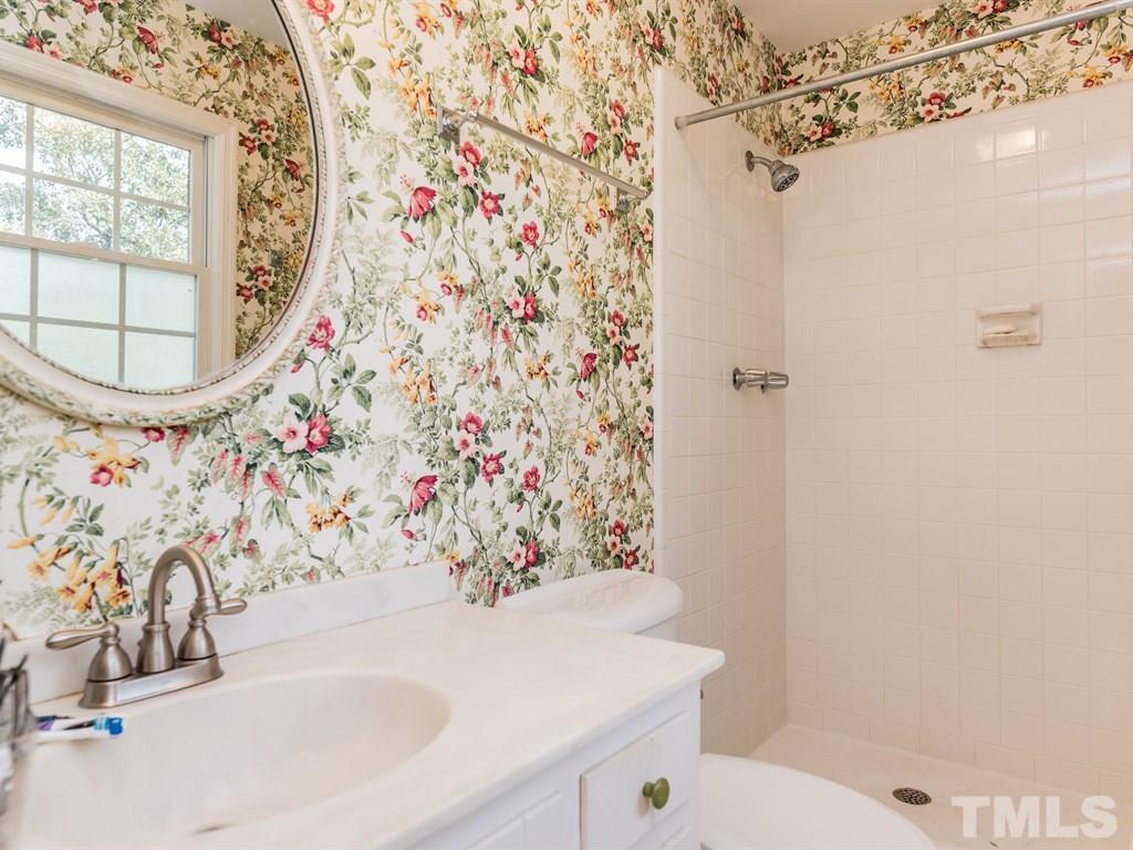 1213 Hunting Ridge Road Raleigh, NC 27615 - Photo 22 of 25 a bathroom with a sink and a mirror