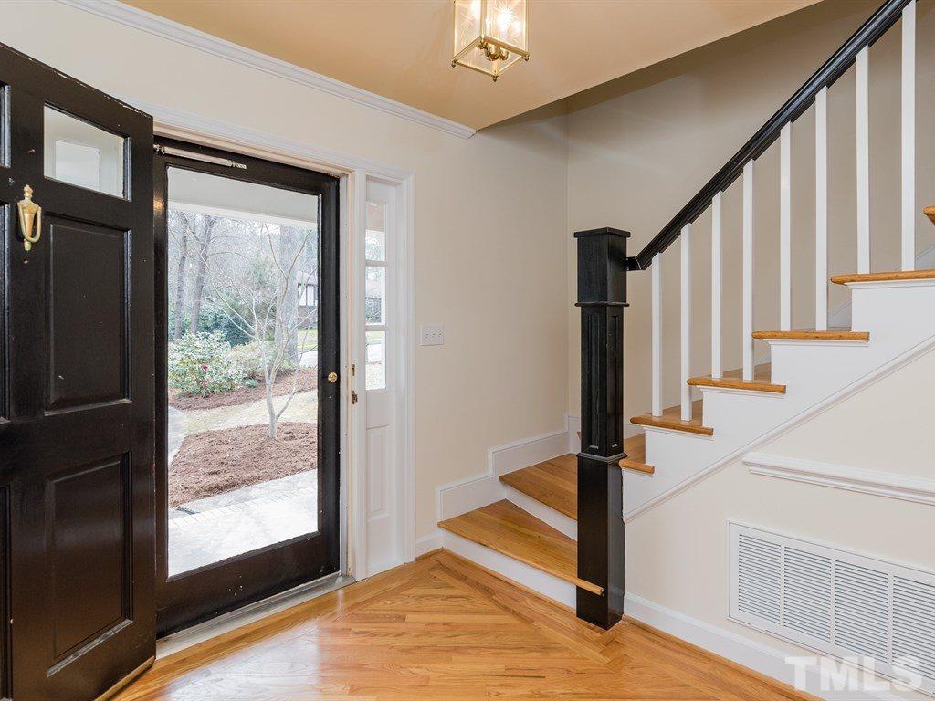 1213 Hunting Ridge Road Raleigh, NC 27615 - Photo 4 of 25 a view of an entryway with wooden floor and door
