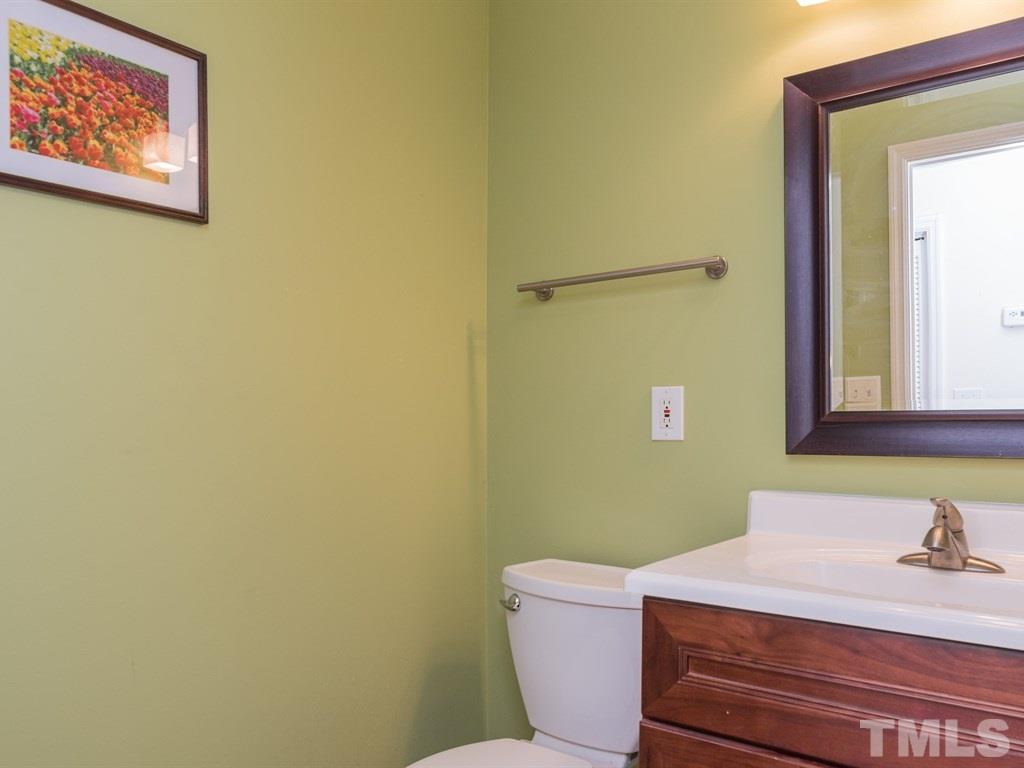 1213 Hunting Ridge Road Raleigh, NC 27615 - Photo 5 of 25 a bathroom with a sink and a mirror