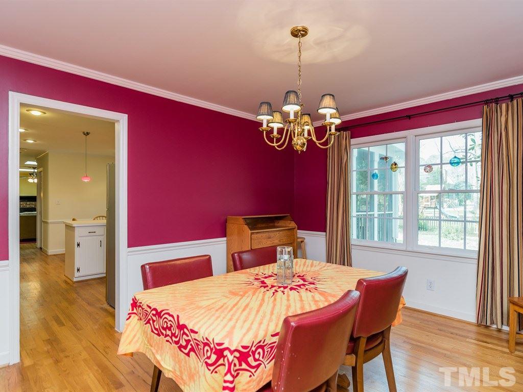 1213 Hunting Ridge Road Raleigh, NC 27615 - Photo 8 of 25 a bedroom with a bed and a chandelier