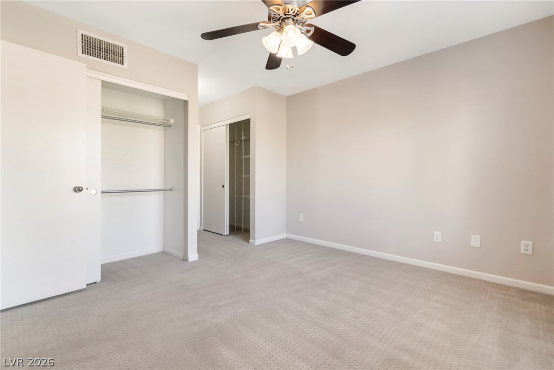 8070 West Russell Road, Unit 2006 Las Vegas, NV 89113 - Photo 23 of 24 A well-lit bedroom with ample closet space and plush carpeting offers peaceful repose.