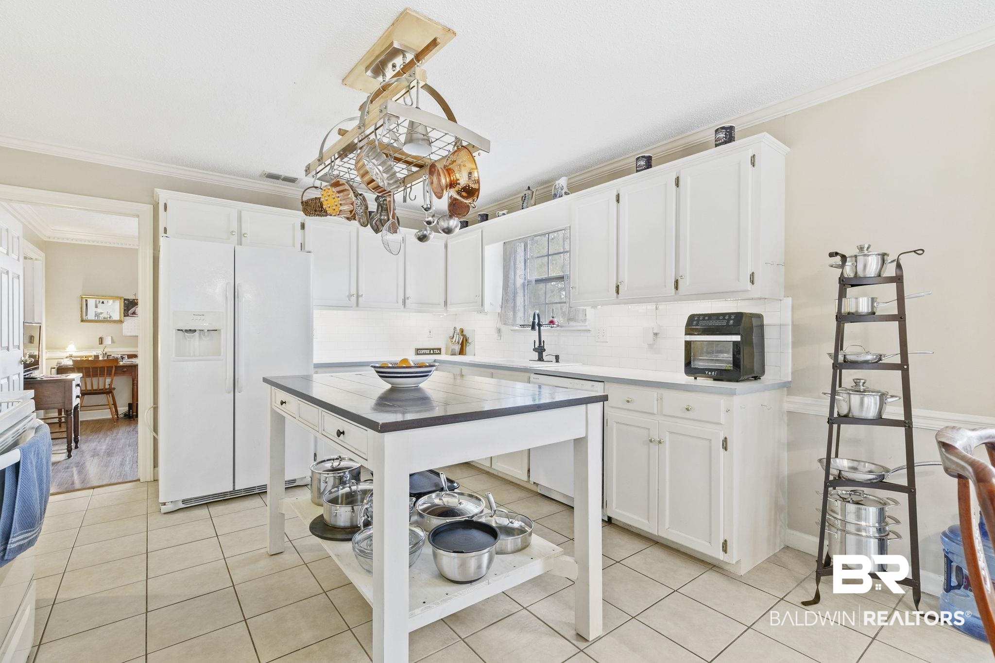 22 Pirates Lane Daphne, AL 36527 - Photo 12 of 36 Kitchen featuring crown molding, white cabinets, and white appliances