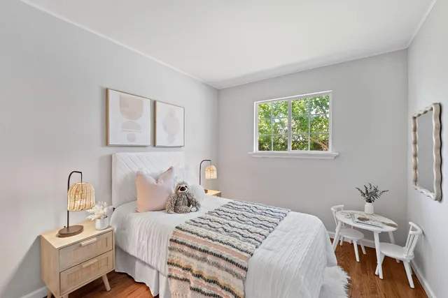 a bedroom with a bed and a table in it