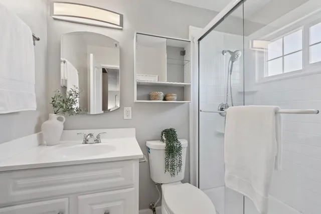 a bathroom with a sink toilet and shower