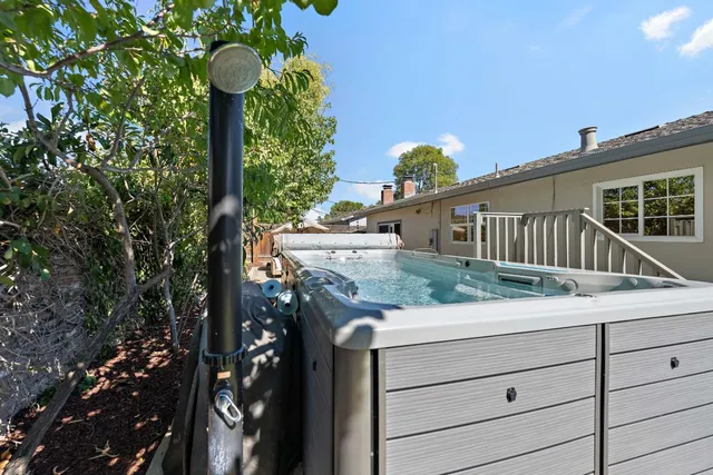 a view of a house with a wooden fence