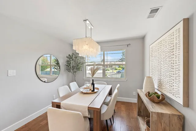 a dining room with furniture and a window
