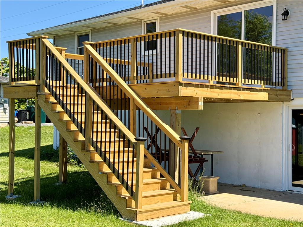3508 Nazareth Road Easton, PA 18045 - Photo 3 of 25 A brand new inviting wooden deck with a staircase descends to a grassy yard.