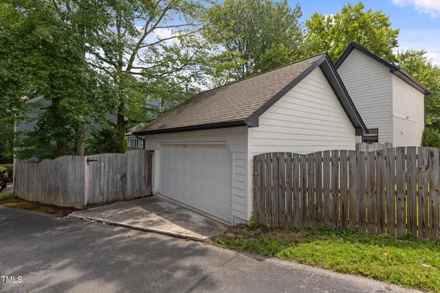 a view of a brick house with wooden fence