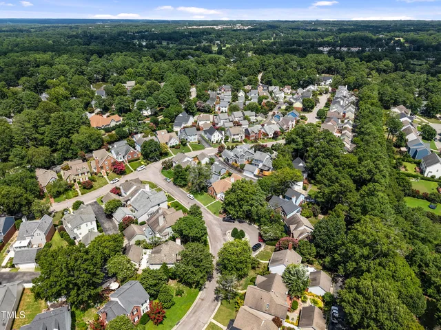 an aerial view of a house with a street view