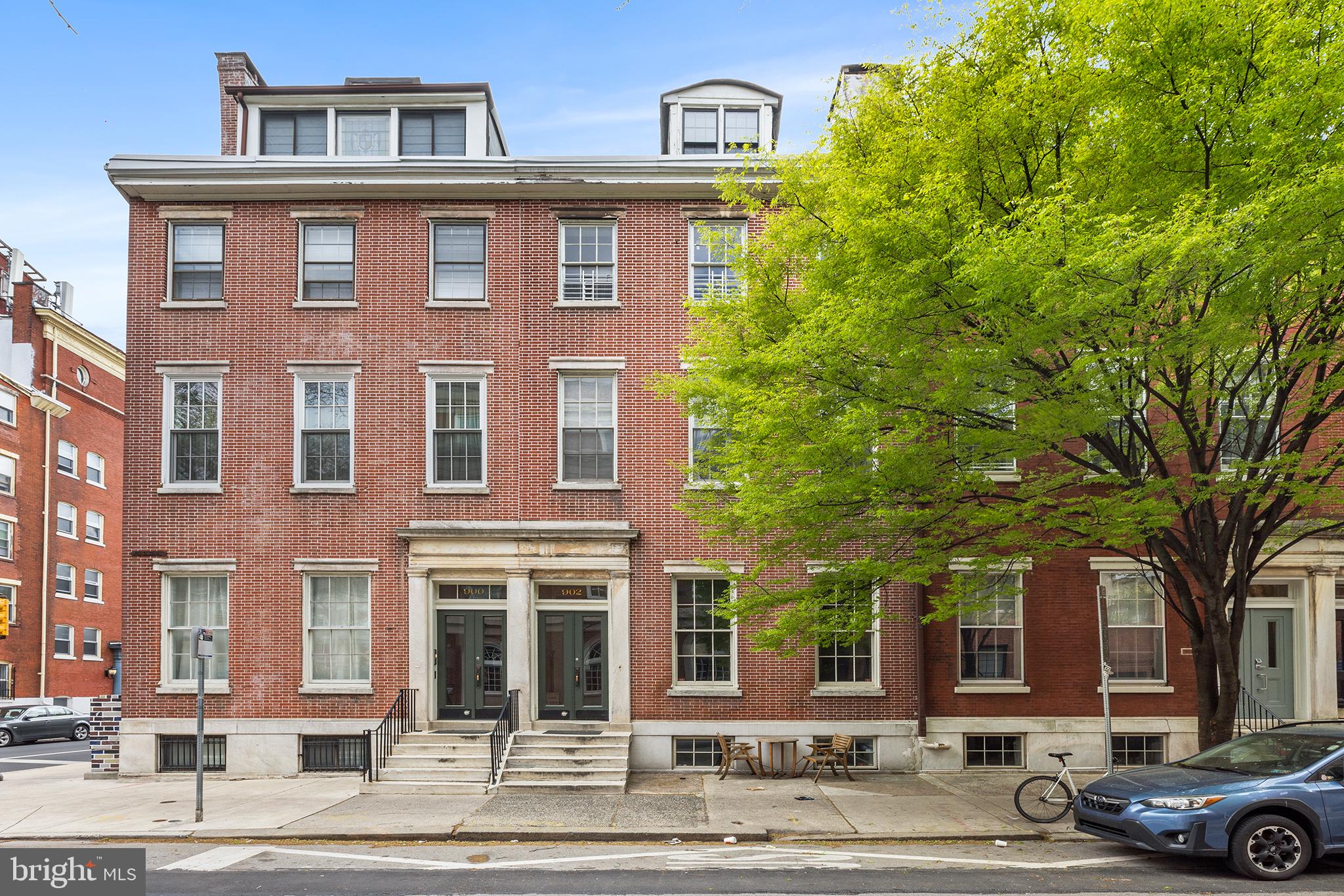 902 Pine Street, Unit 3F Philadelphia, PA 19107 - Photo 1 of 22 a front view of a residential apartment building with a yard
