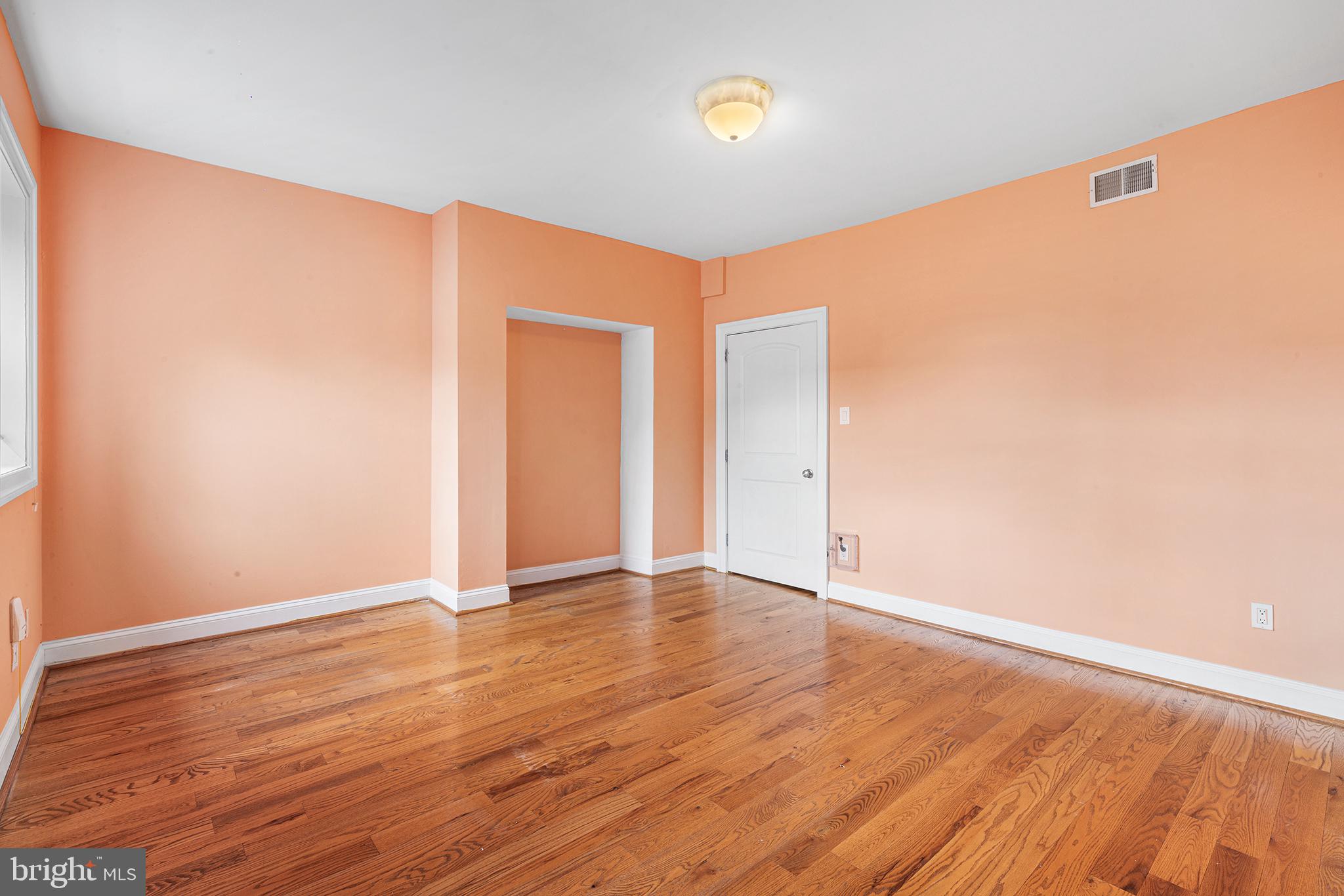 902 Pine Street, Unit 3F Philadelphia, PA 19107 - Photo 17 of 22 an empty room with wooden floor and windows