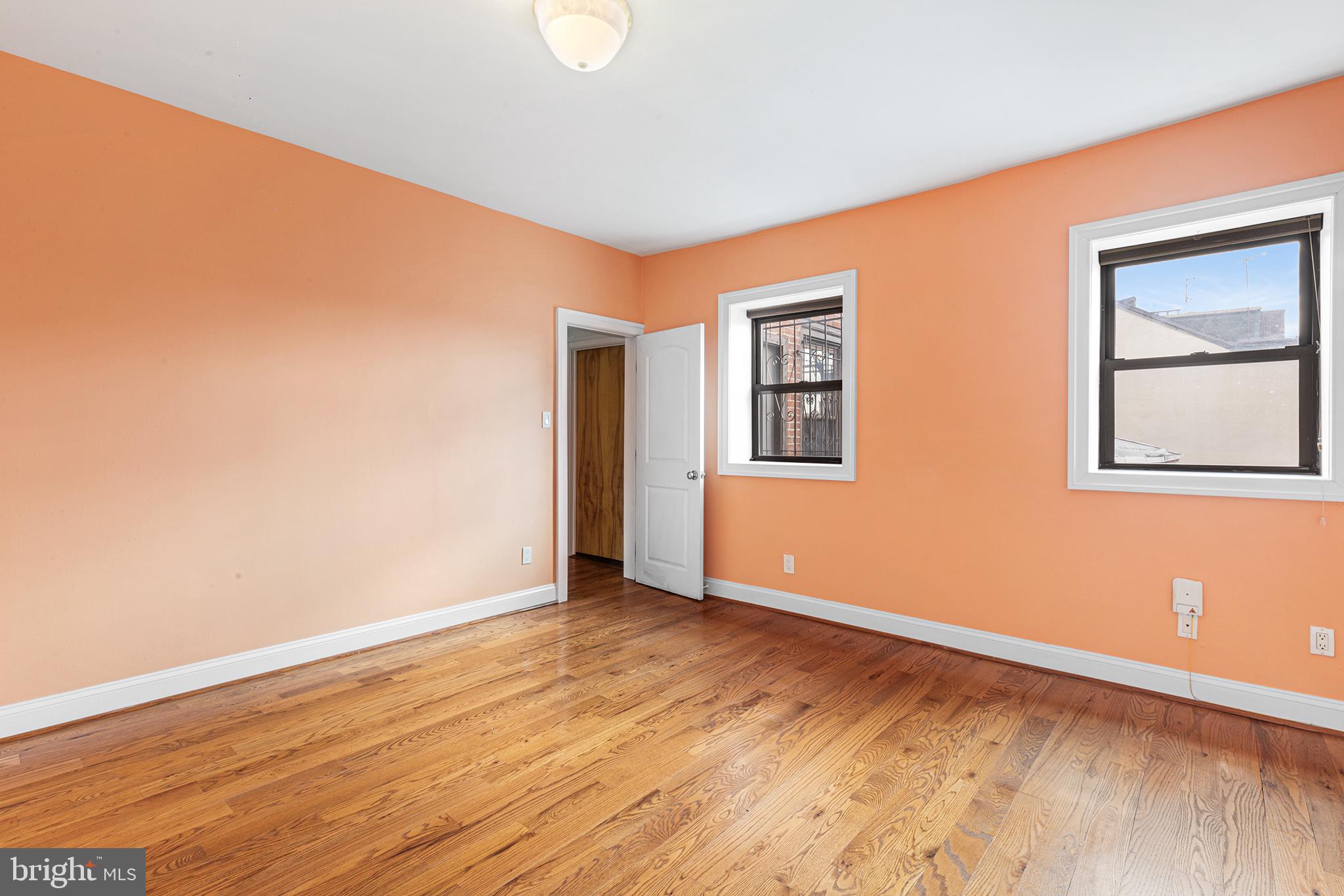 902 Pine Street, Unit 3F Philadelphia, PA 19107 - Photo 19 of 22 a view of an empty room with wooden floor and a window