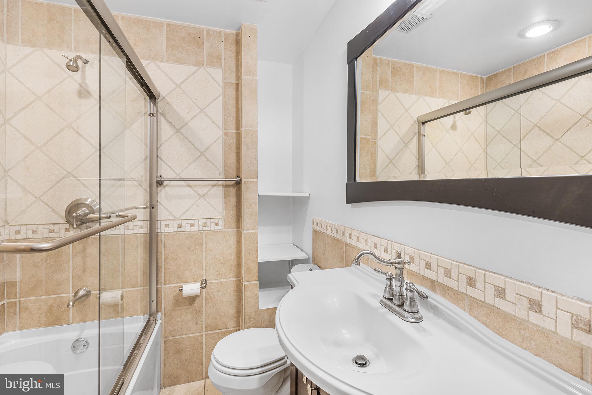 902 Pine Street, Unit 3F Philadelphia, PA 19107 - Photo 21 of 22 a bathroom with a sink and a mirror