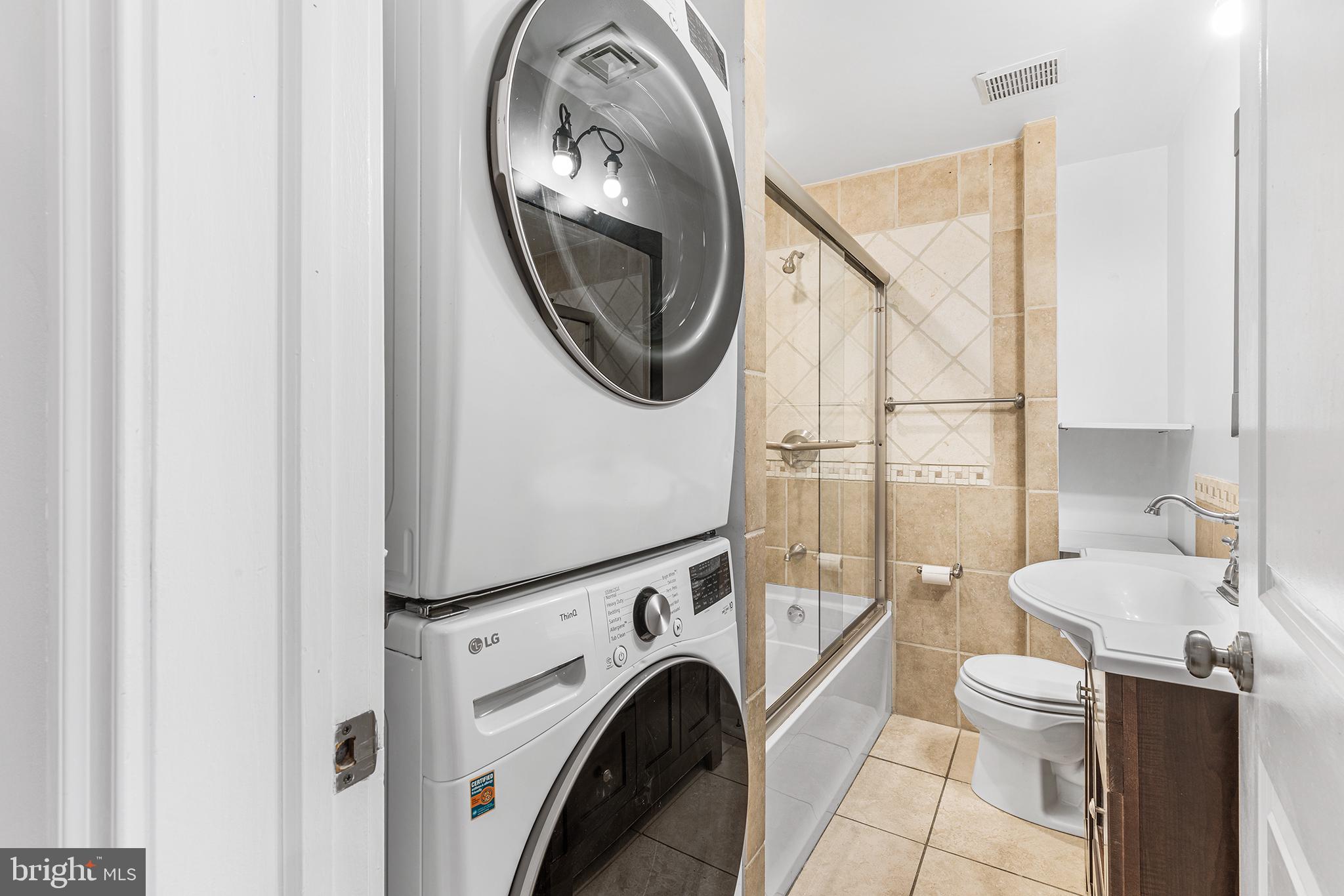 902 Pine Street, Unit 3F Philadelphia, PA 19107 - Photo 22 of 22 a view of a hallway with washer and dryer