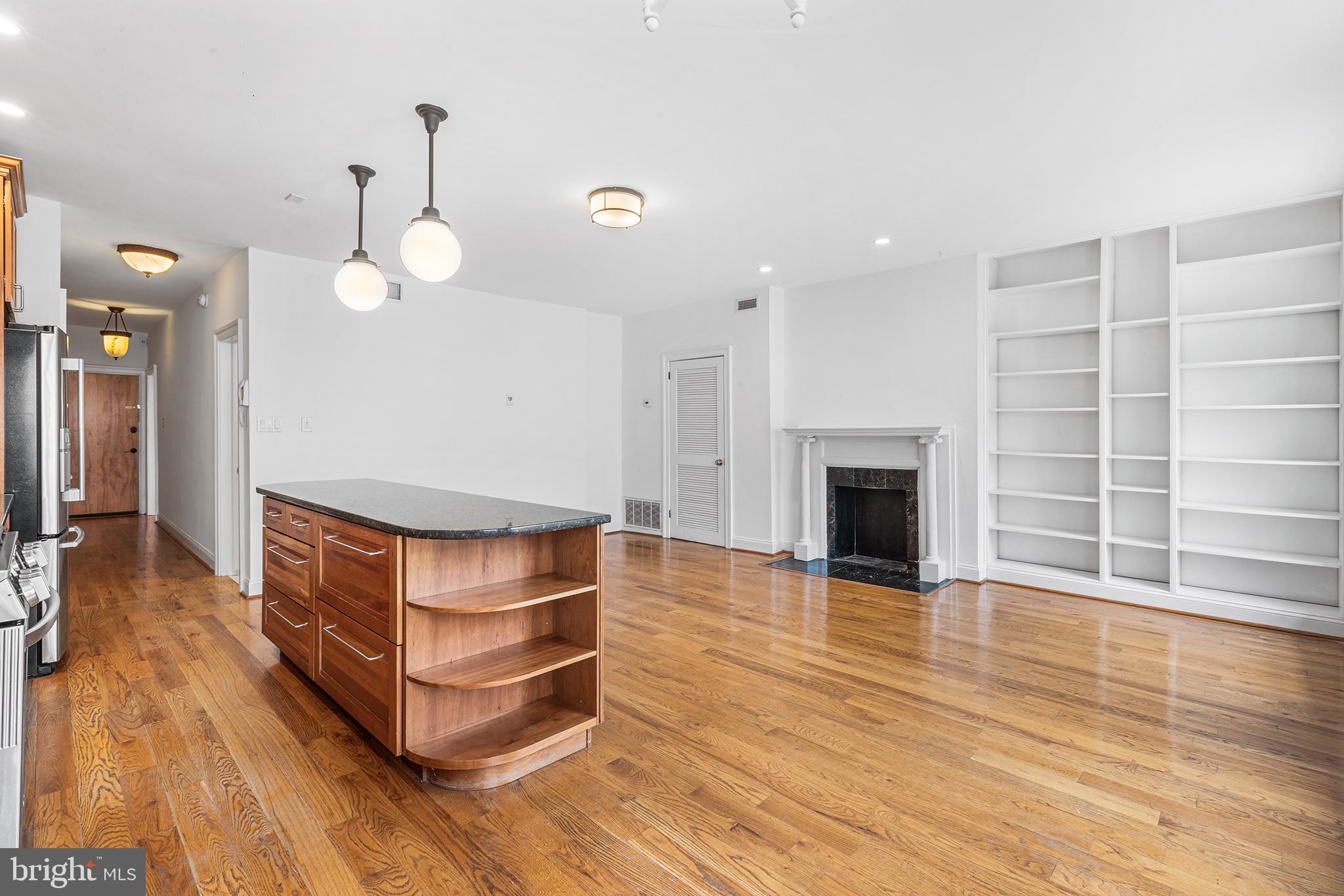 902 Pine Street, Unit 3F Philadelphia, PA 19107 - Photo 4 of 22 a room with wooden floors and a fireplace