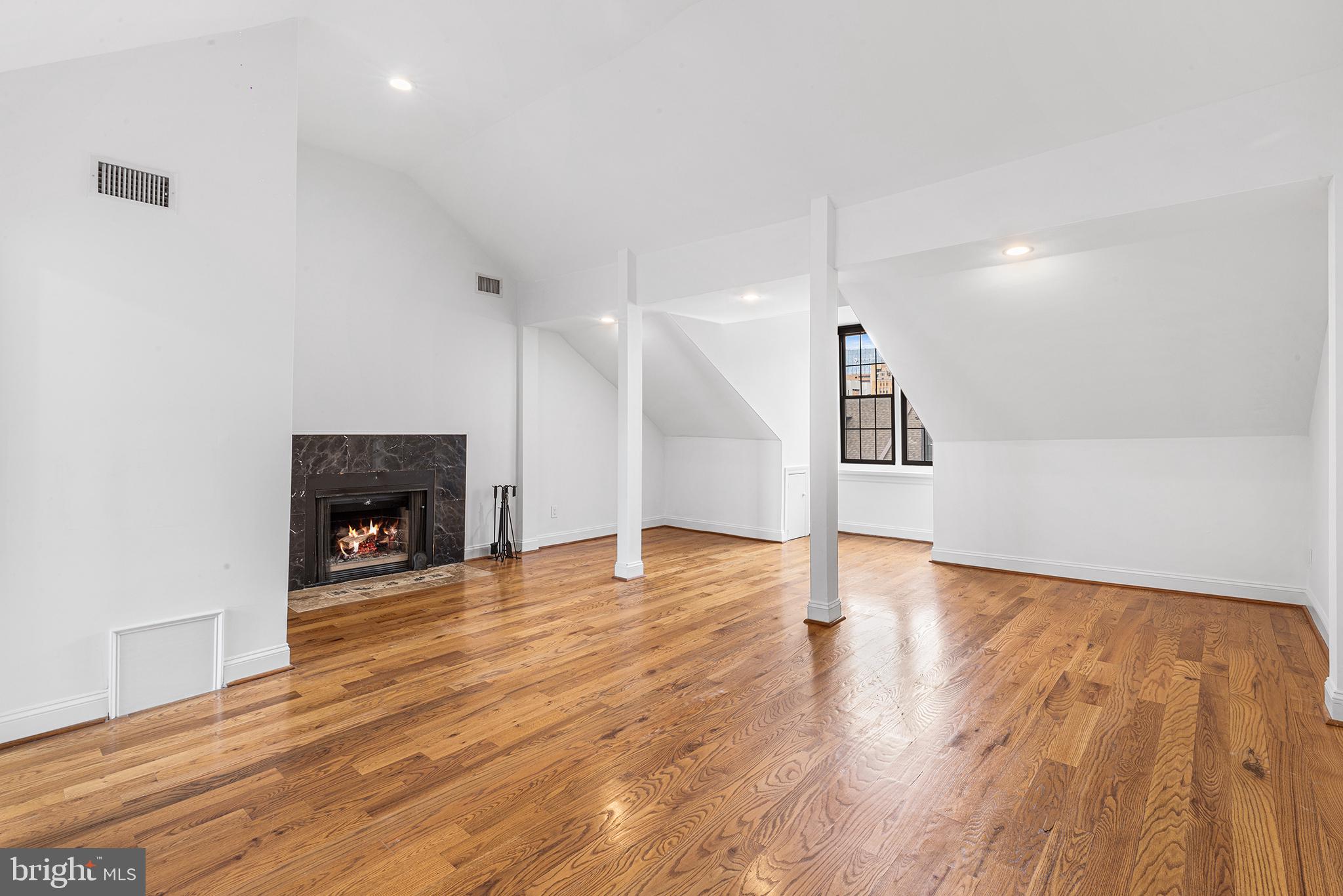 902 Pine Street, Unit 3F Philadelphia, PA 19107 - Photo 10 of 22 a view of empty room with wooden floor and fireplace