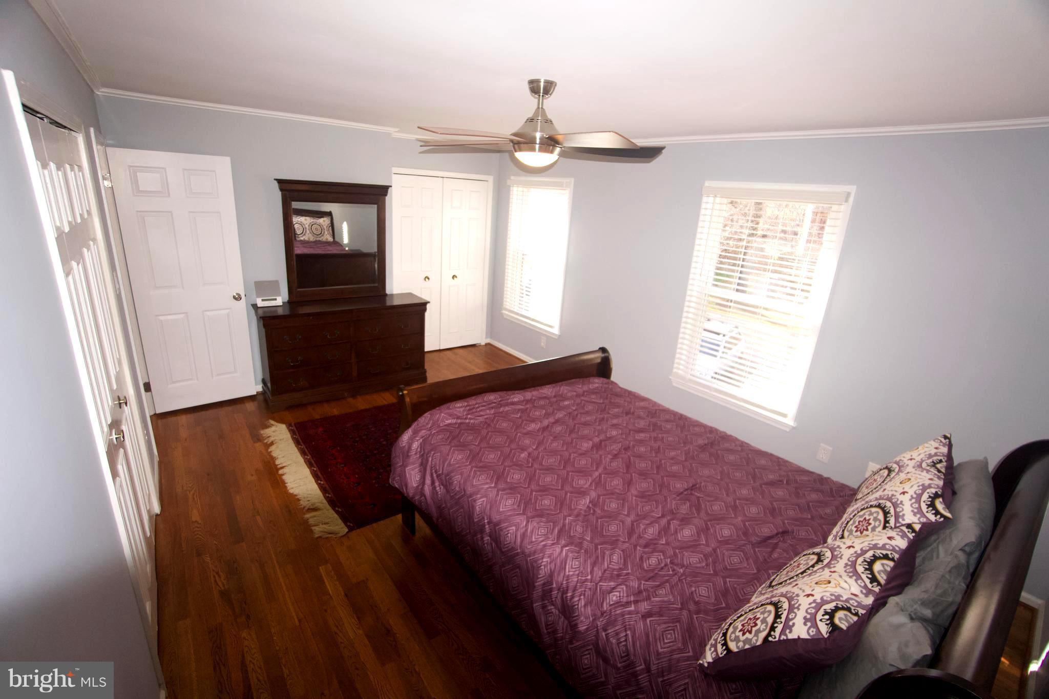 6261 Rathlin Drive Springfield, VA 22152 - Photo 13 of 26 a bedroom with a bed and wooden floor