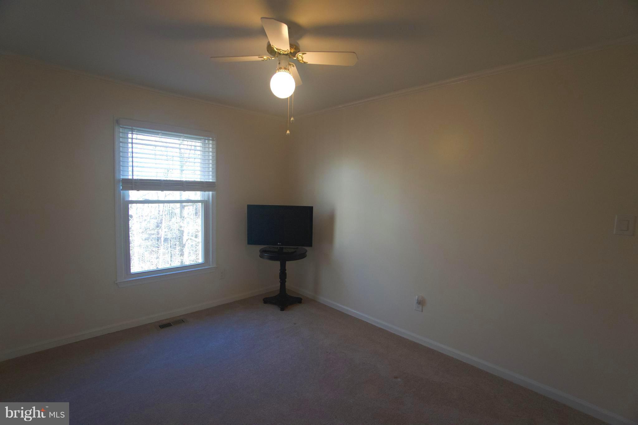 6261 Rathlin Drive Springfield, VA 22152 - Photo 16 of 26 an empty room with windows and fan