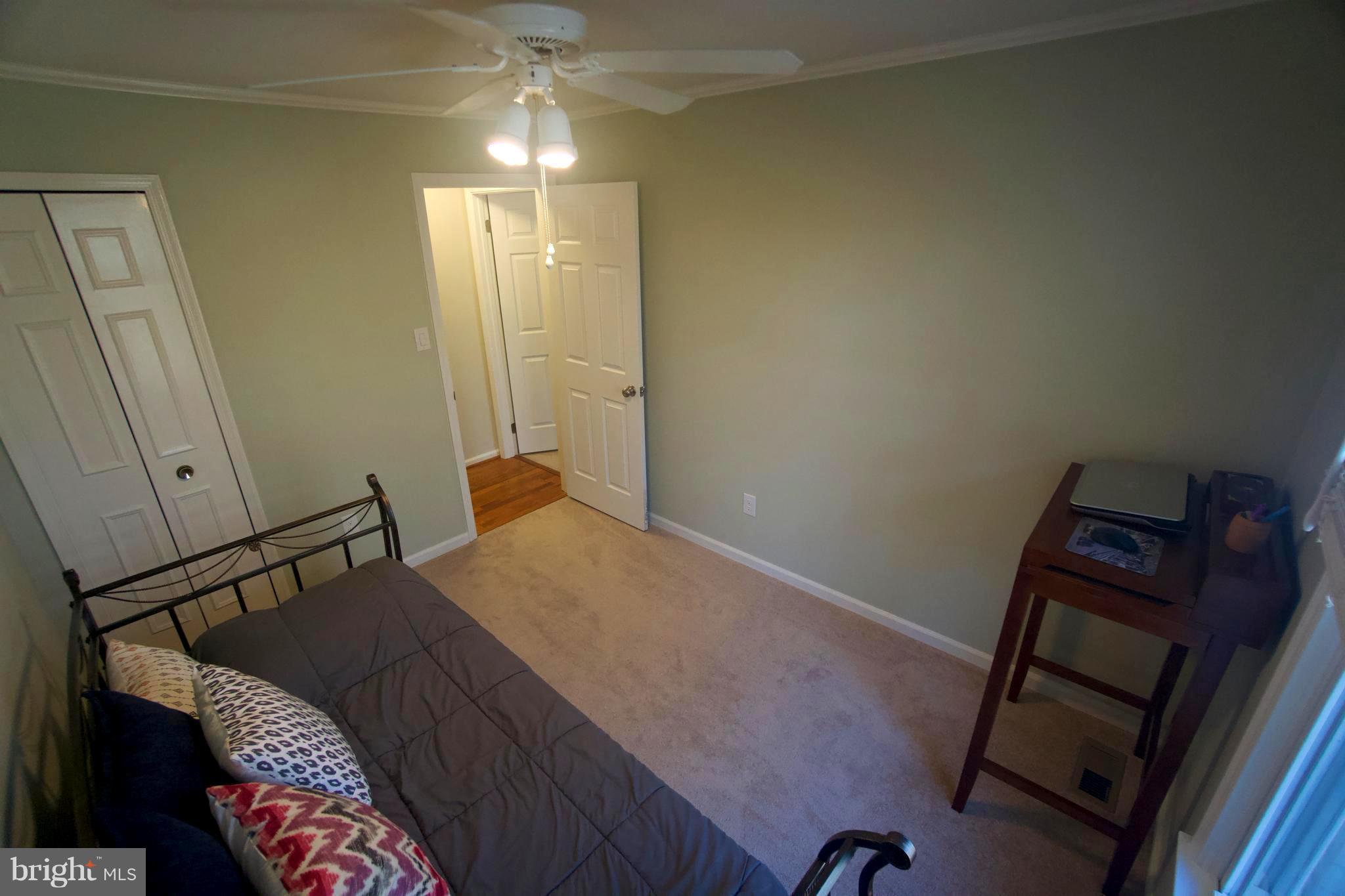 6261 Rathlin Drive Springfield, VA 22152 - Photo 17 of 26 a bedroom with a bed and a mirror