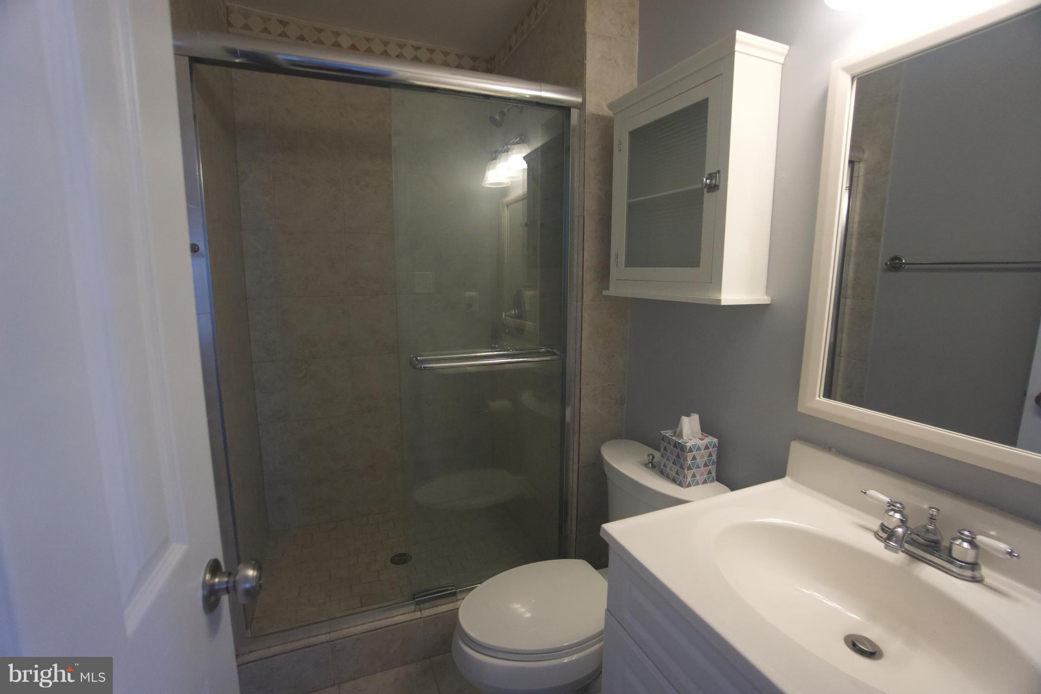 6261 Rathlin Drive Springfield, VA 22152 - Photo 19 of 26 a bathroom with a sink toilet and shower