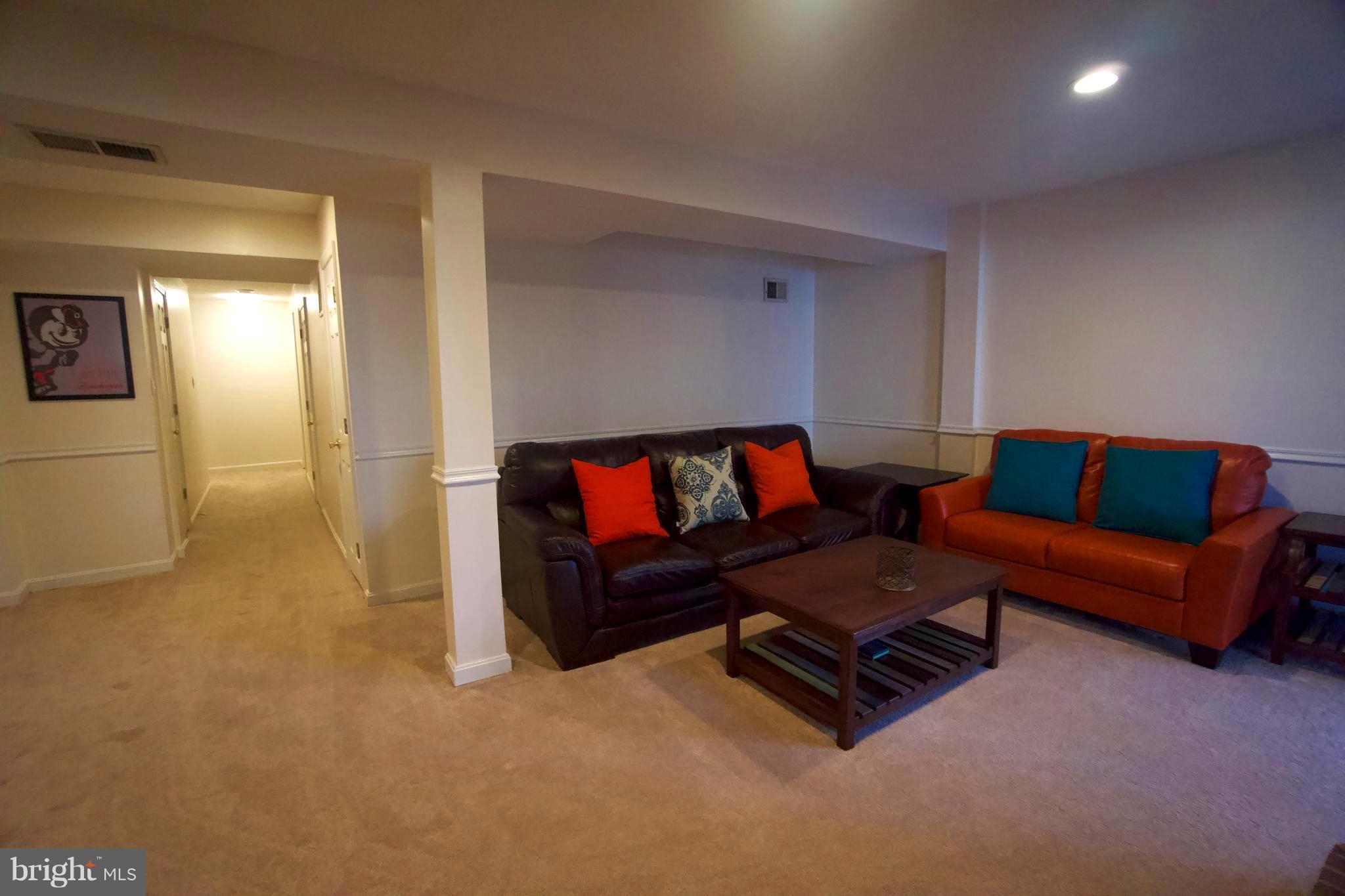 6261 Rathlin Drive Springfield, VA 22152 - Photo 22 of 26 a living room with furniture and a flat screen tv