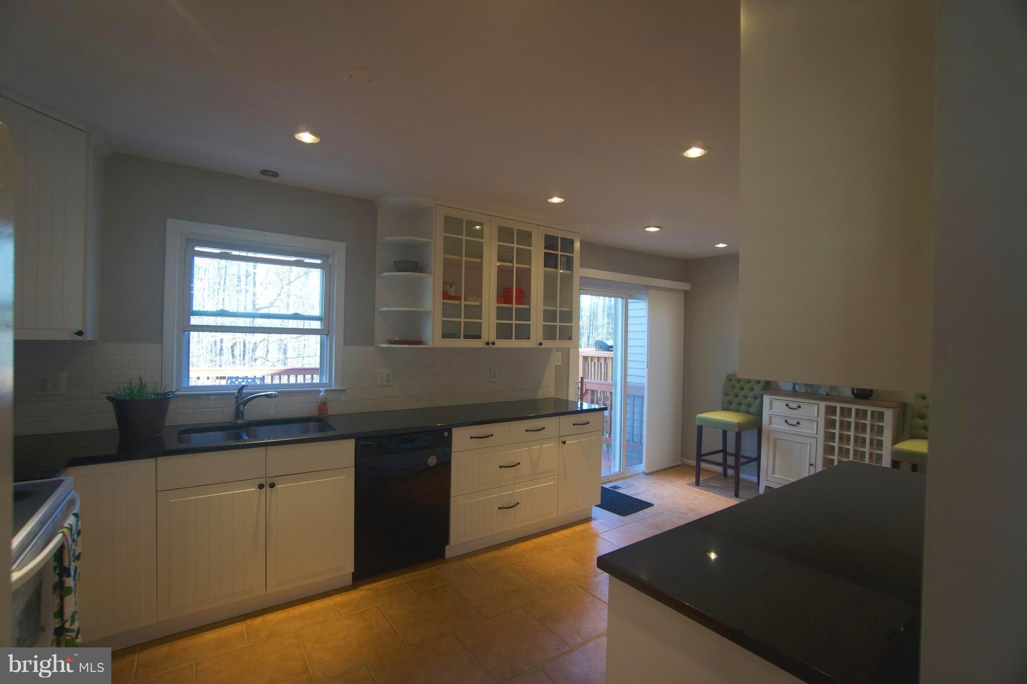 6261 Rathlin Drive Springfield, VA 22152 - Photo 6 of 26 a kitchen with granite countertop a sink and a stove top oven