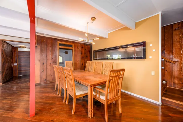 a kitchen with granite countertop a sink and white cabinets