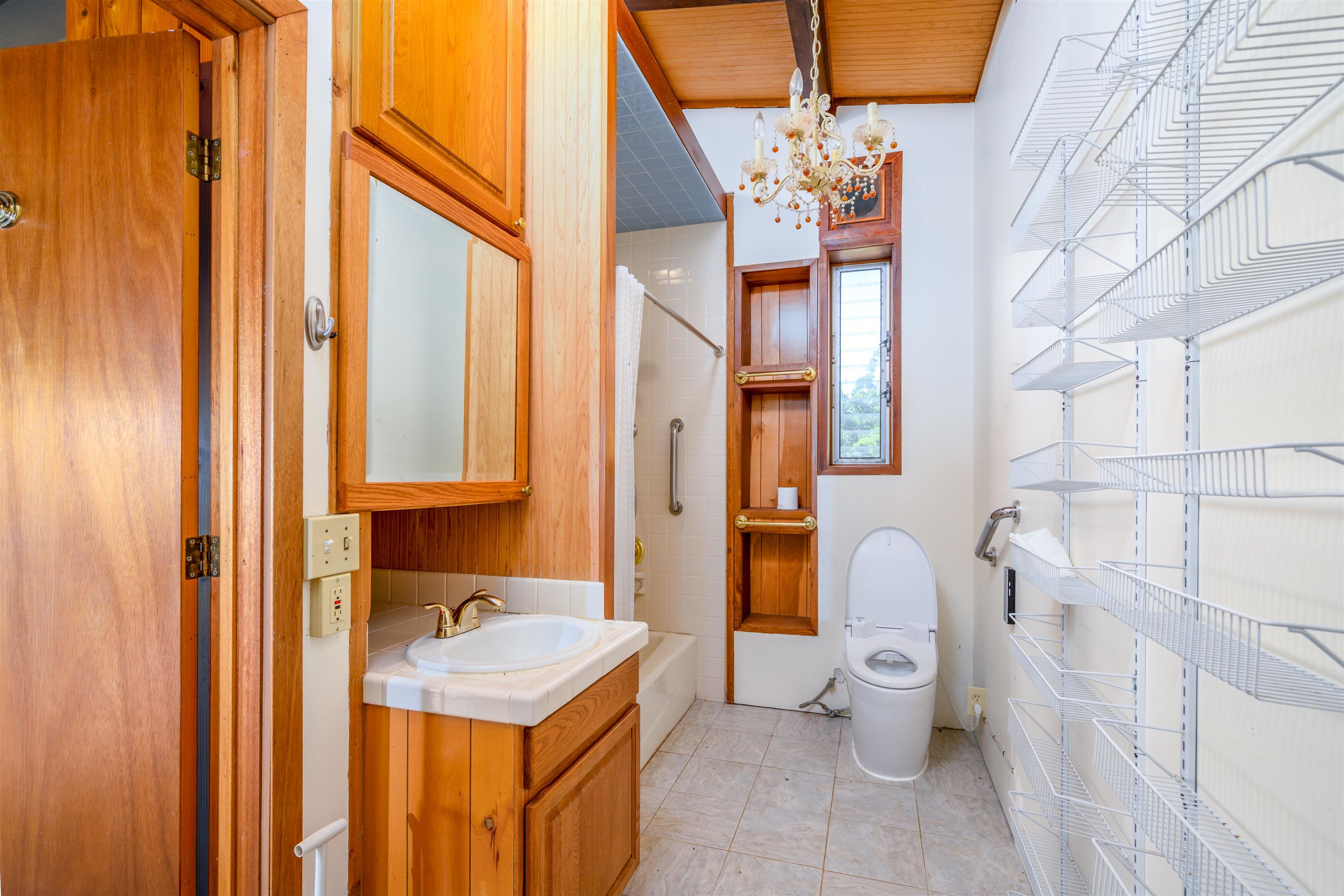 810 Upper Ulumalu Road Haiku, HI 96708 - Photo 24 of 46 a bathroom with a sink a toilet and shower curtain