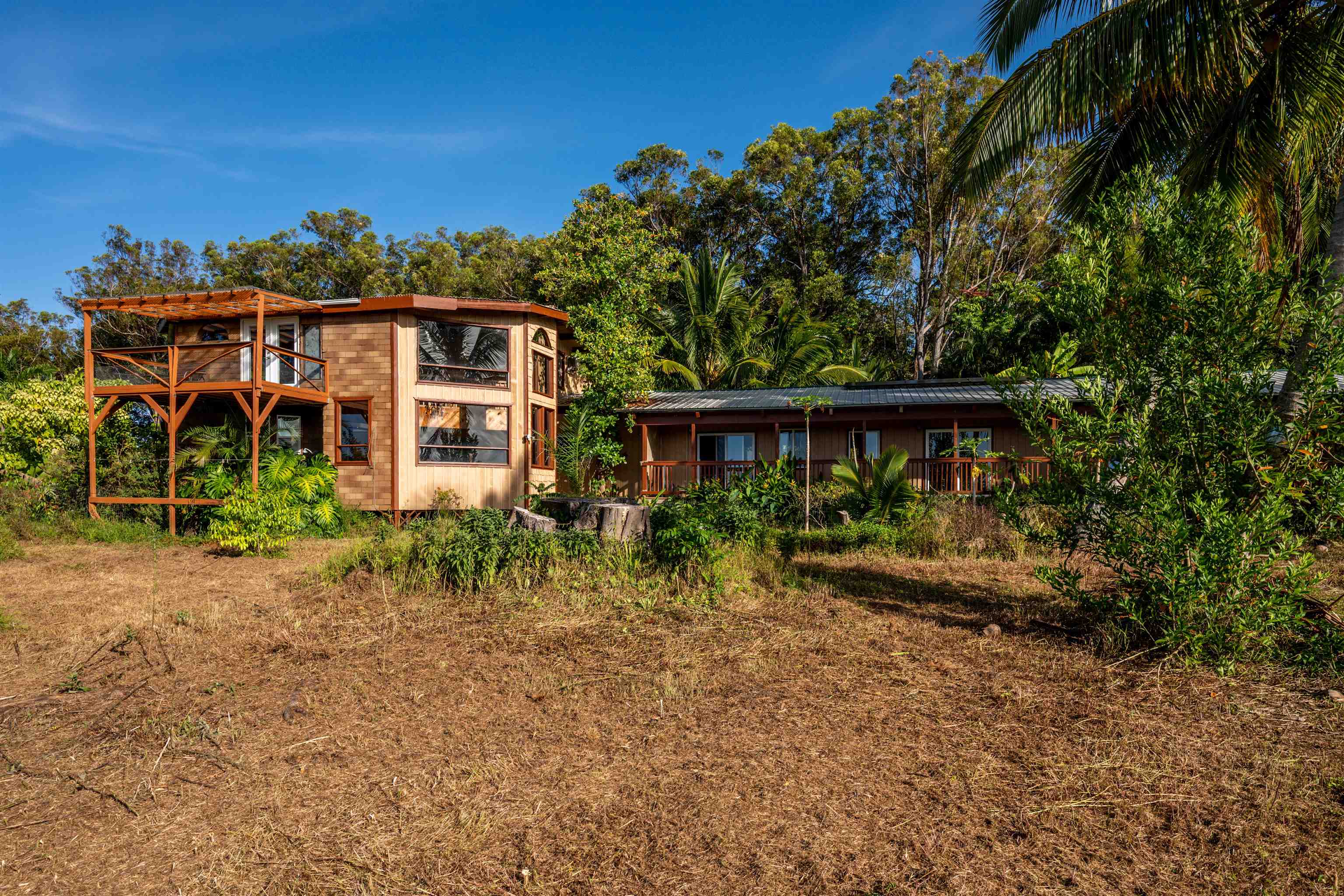 810 Upper Ulumalu Road Haiku, HI 96708 - Photo 10 of 46 a front view of a house with a yard