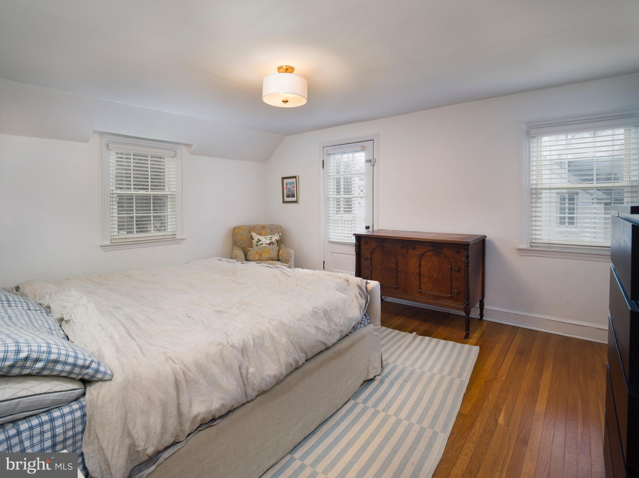 312 Old Lancaster Road Devon, PA 19333 - Photo 16 of 25 a spacious bedroom with a bed and wooden floor