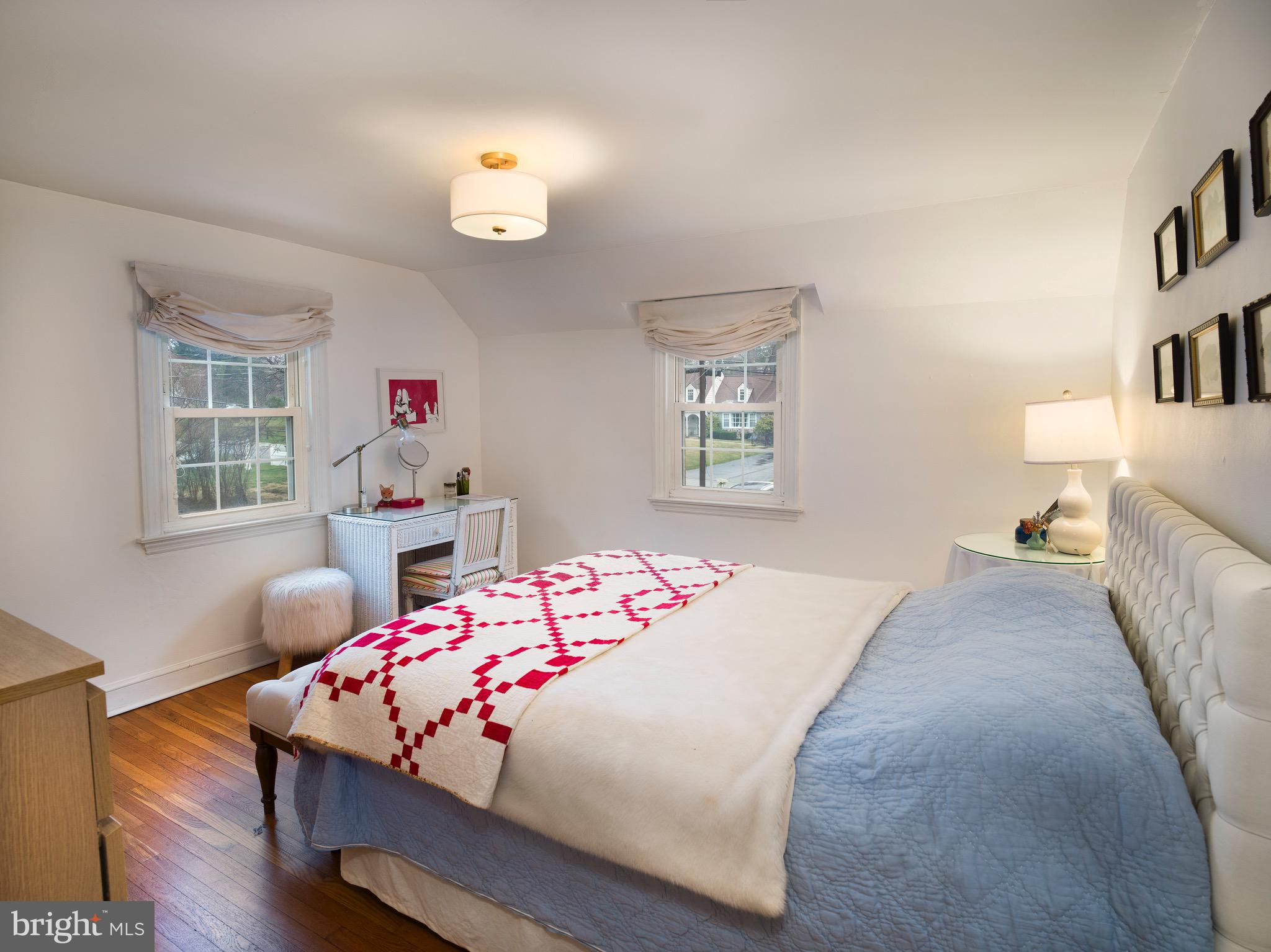 312 Old Lancaster Road Devon, PA 19333 - Photo 19 of 25 a bedroom with a bed and wooden floor