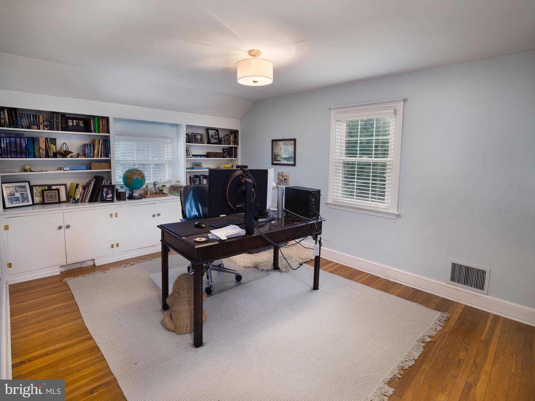 312 Old Lancaster Road Devon, PA 19333 - Photo 20 of 25 a living room with furniture a piano and a bookshelf