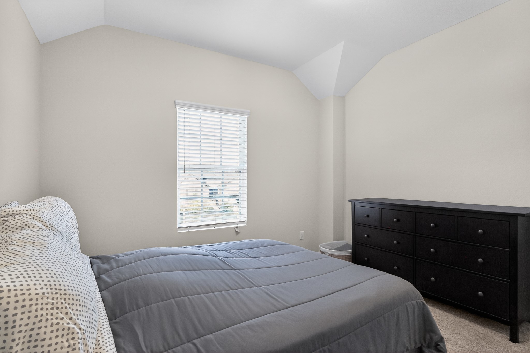 114 Bosco Road Hutto, TX 78634 - Photo 27 of 39 Well-lit sleeping quarters with a vaulted ceiling and a clean, neutral palette.