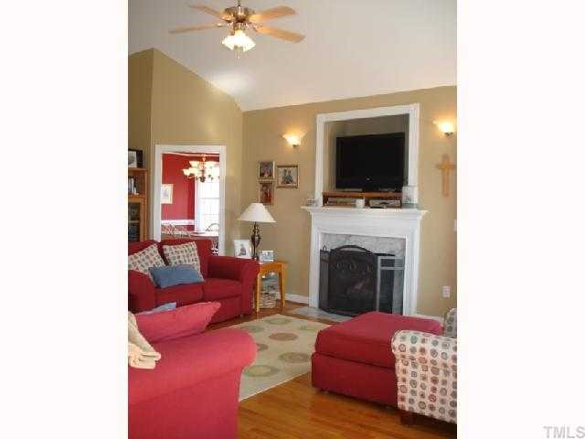 1221 Red Brick Road Garner, NC 27529 - Photo 4 of 11 a living room with furniture a flat screen tv and a fireplace