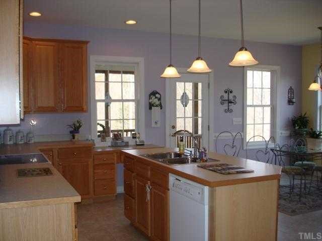 1221 Red Brick Road Garner, NC 27529 - Photo 5 of 11 a kitchen with granite countertop a sink a stove and cabinets