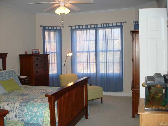 1221 Red Brick Road Garner, NC 27529 - Photo 7 of 11 a bedroom with a bed and a chandelier